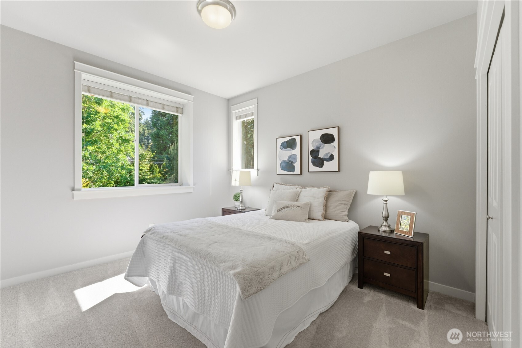 One of the two south facing bedrooms, filled with soft natural light and views of the garden