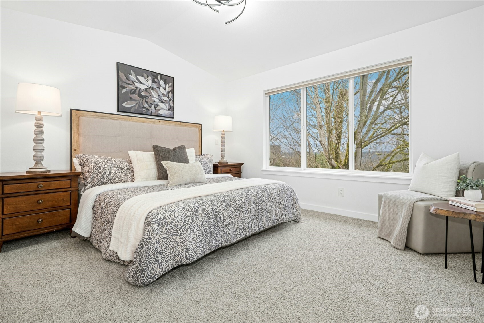 The vaulted primary suite is a showstopper, flooding with natural light and framing those signature PNW views.