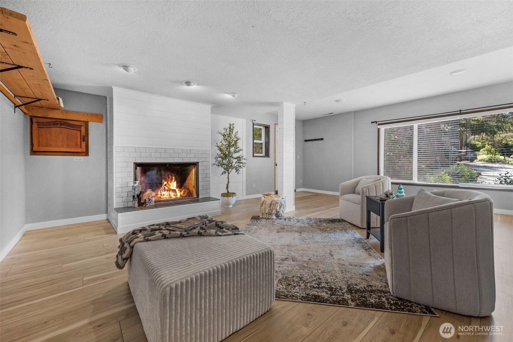 lower level family room with fireplace. Access to side of house on eastside of the home.