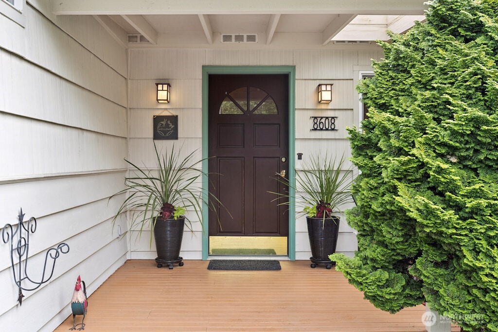 Covered front porch/deck with sunshade provides a nice place to relax