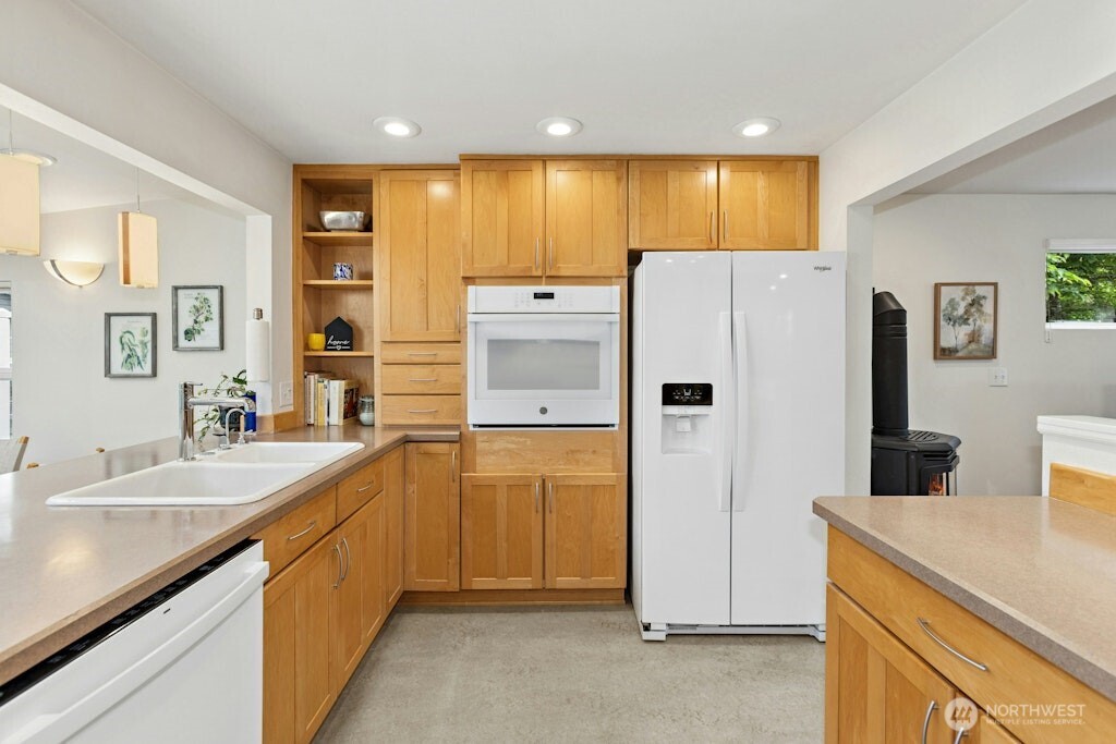 Loads of space and sunlight flood the kitchen from the sunroom/dining area