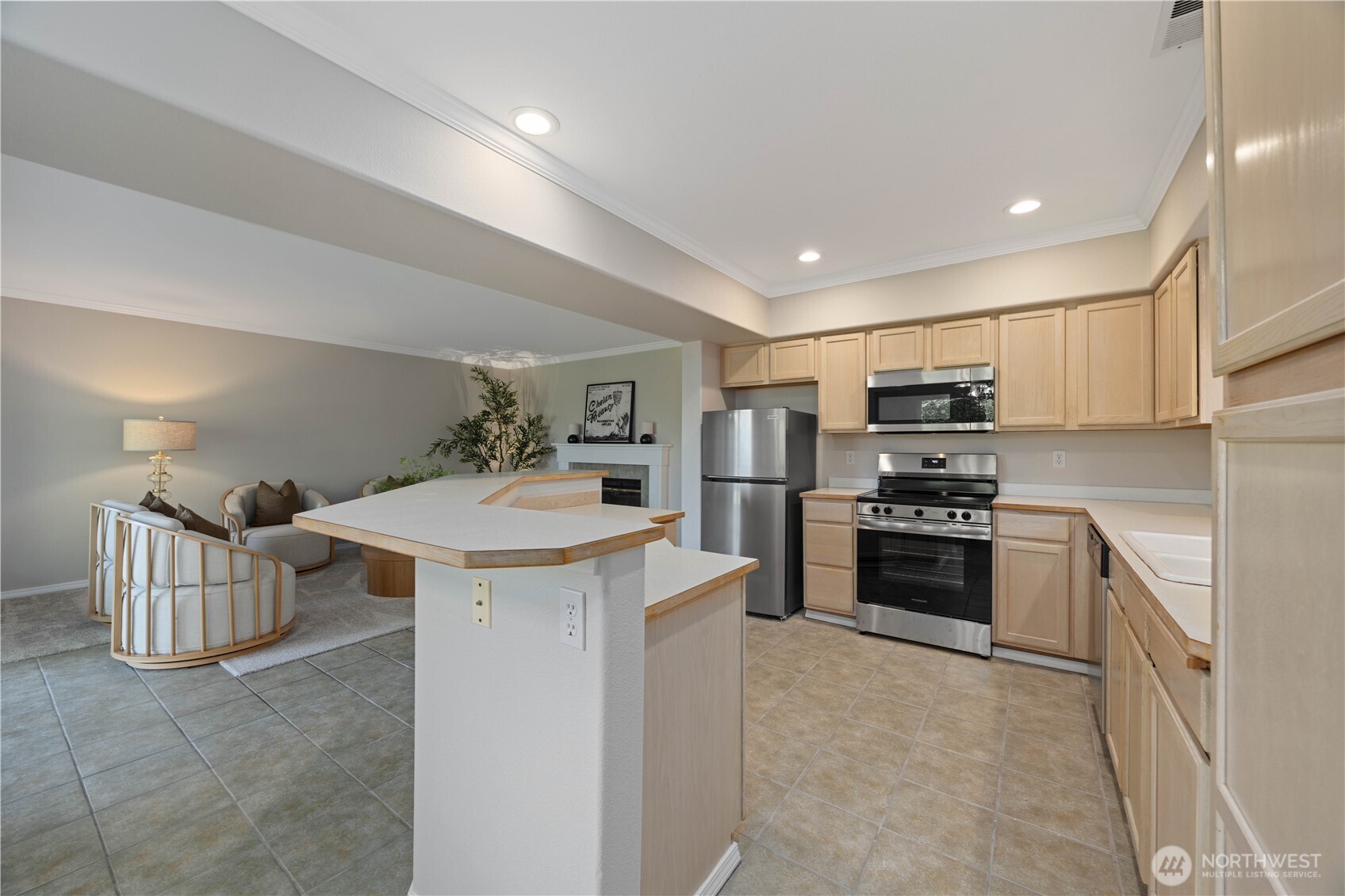 Beautifully updated kitchen featuring new stainless steel appliances, abundant cabinetry, and expansive counter space designed for both everyday living and entertaining. The open-concept layout flows seamlessly into the dining and living areas, while large windows bring in natural light and create a bright, welcoming atmosphere. Clean finishes and modern touches complete this functional and stylish kitchen space.