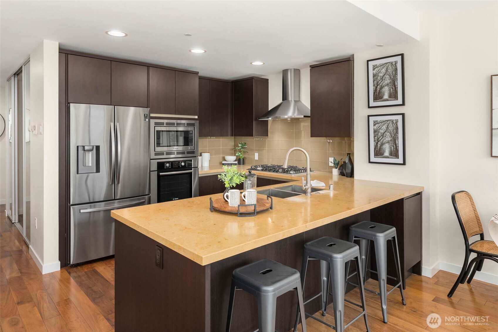 This stylish kitchen provides abundant cabinetry & countertop space, quality appliances with smart fridge, & functional design.
