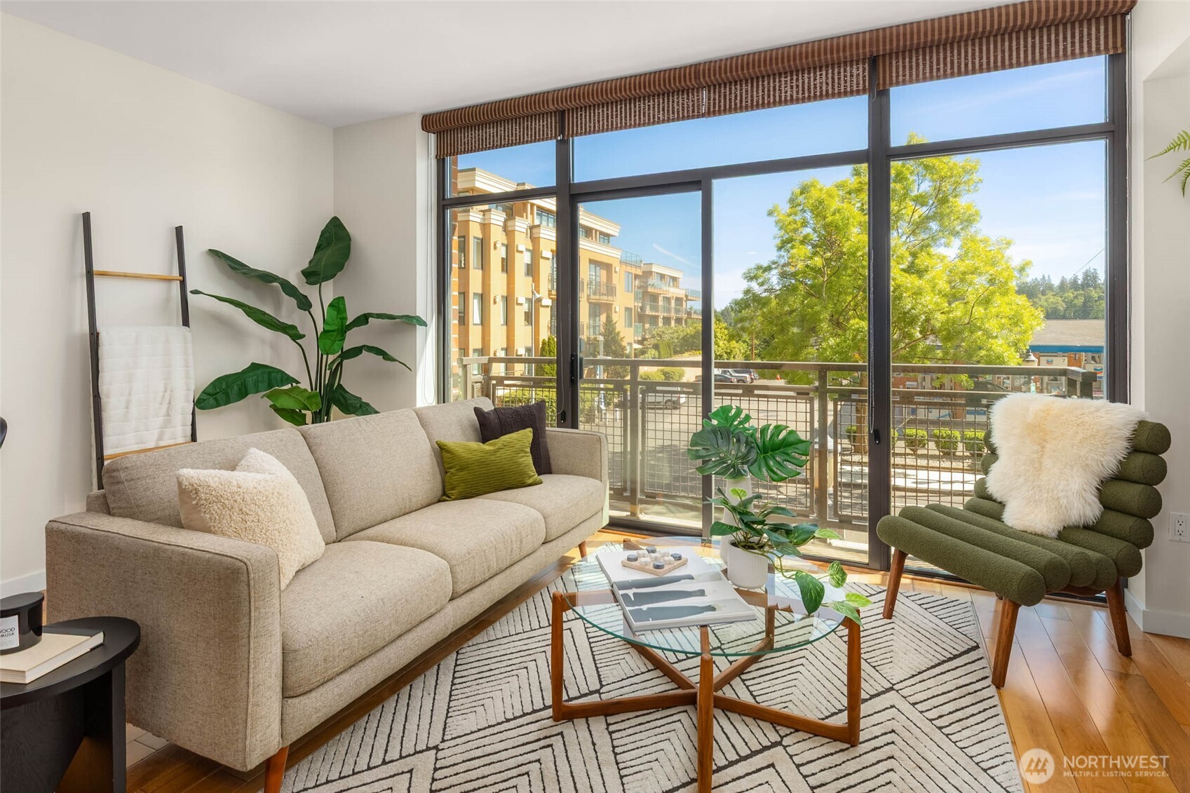A dramatic wall of floor-to-ceiling windows fills the home with cheerful, natural light.