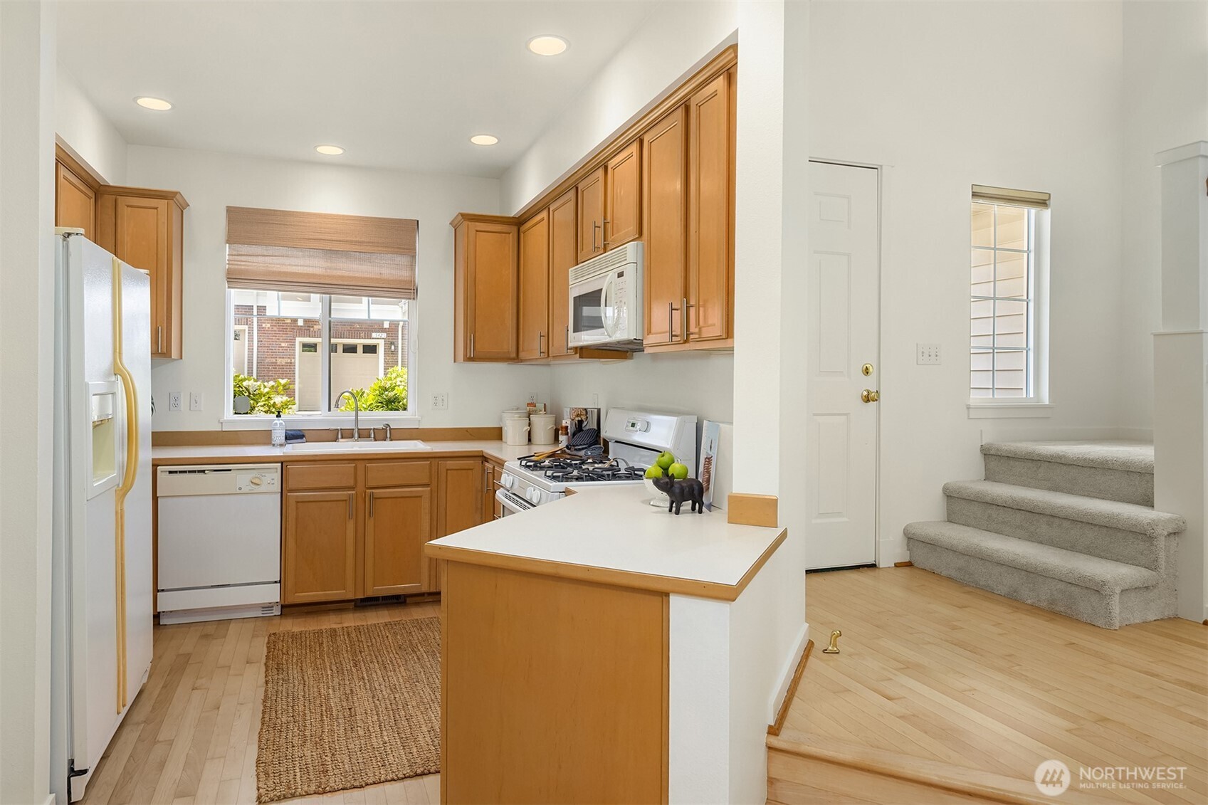 Fresh paint throughout (walls, ceilings, doors, and trim), refinished hardwoods, and new carpet on the upper level make this home move-in ready.