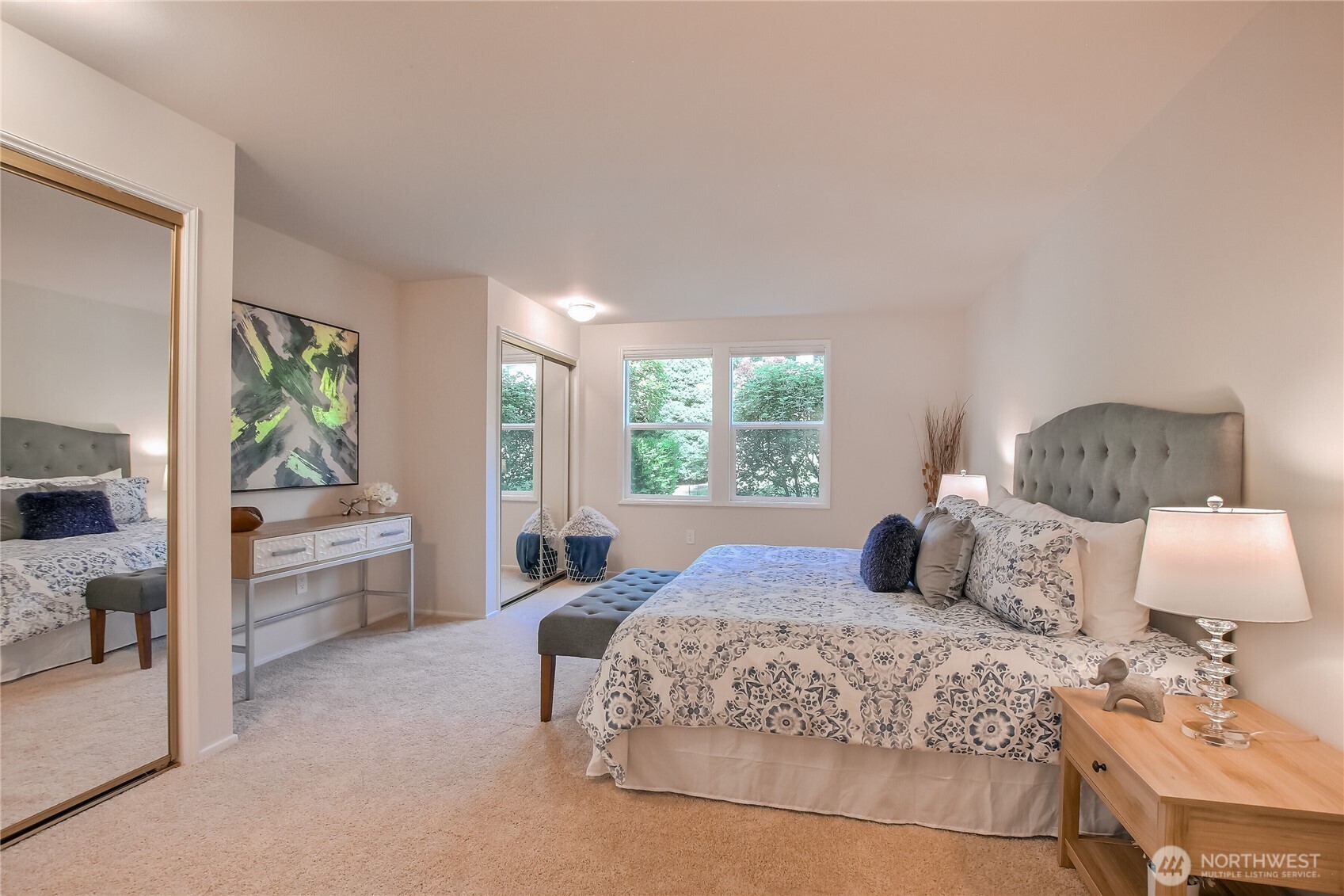 Primary bedroom suite with dual closets and private grass views.