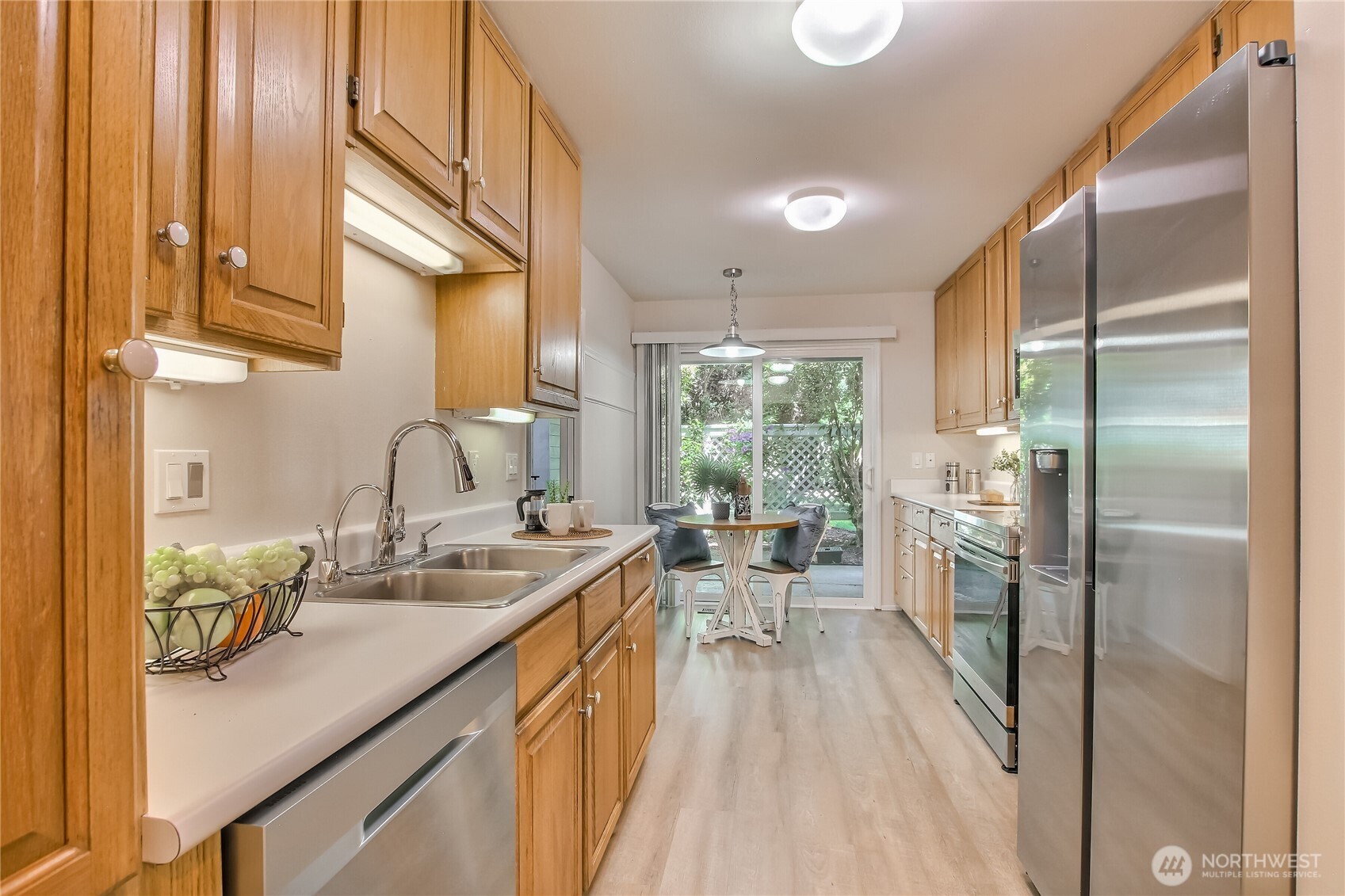 Kitchen/nook with new LVP flooring, newer SS appliances (new microwave), new sink faucet.