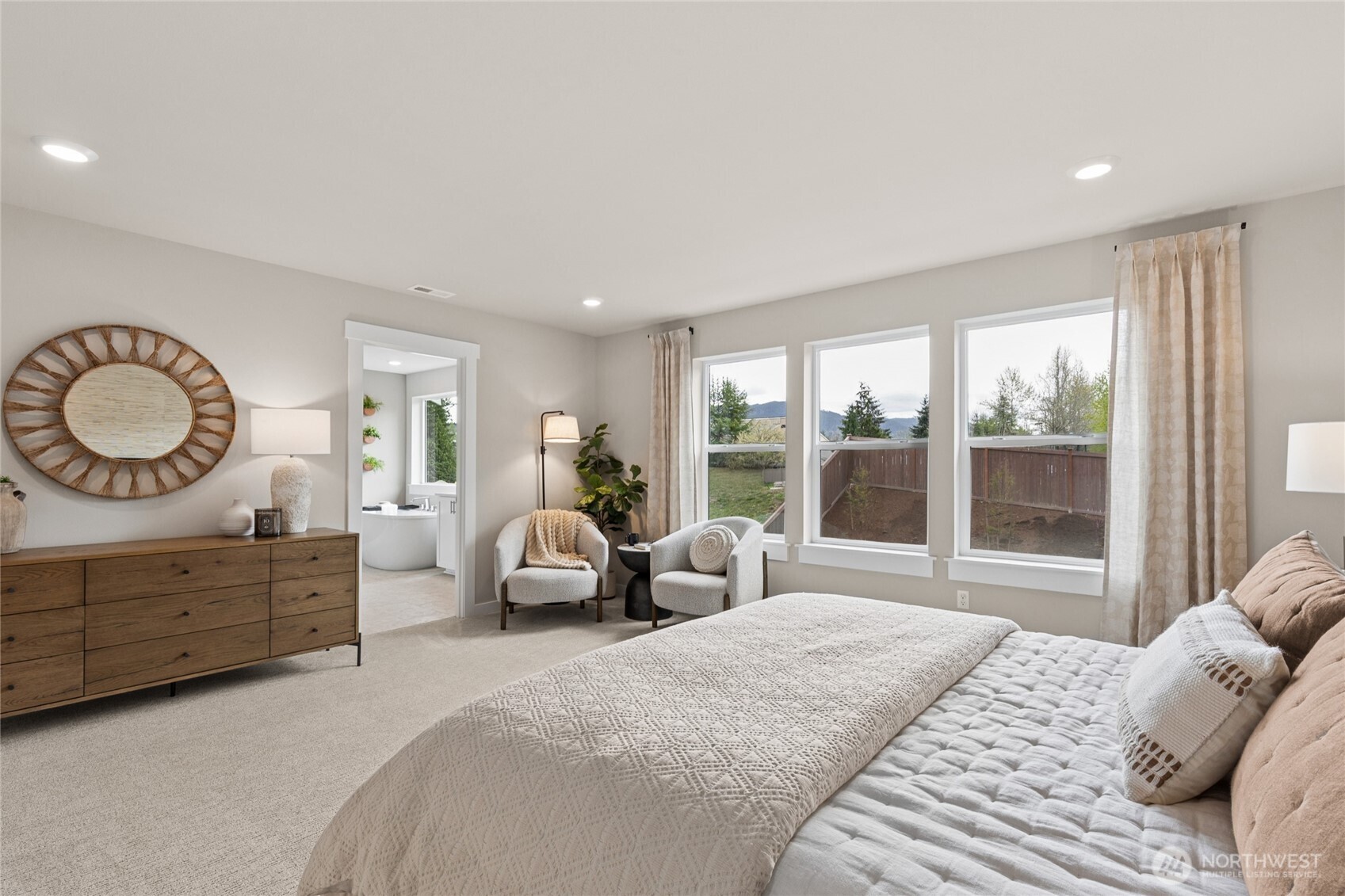 Primary suite is a quiet refuge offering double doors and ample room for oversized King bed