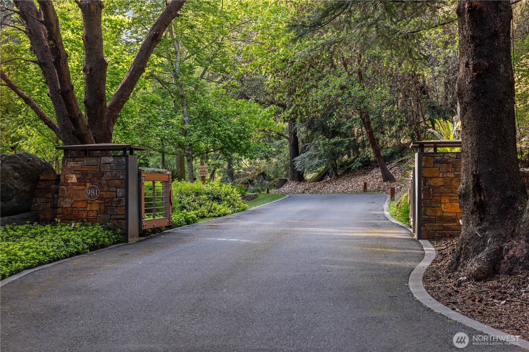The main entrance gate, one of two gated driveways to the property, the second of which leads to the maintenance shop and garage.