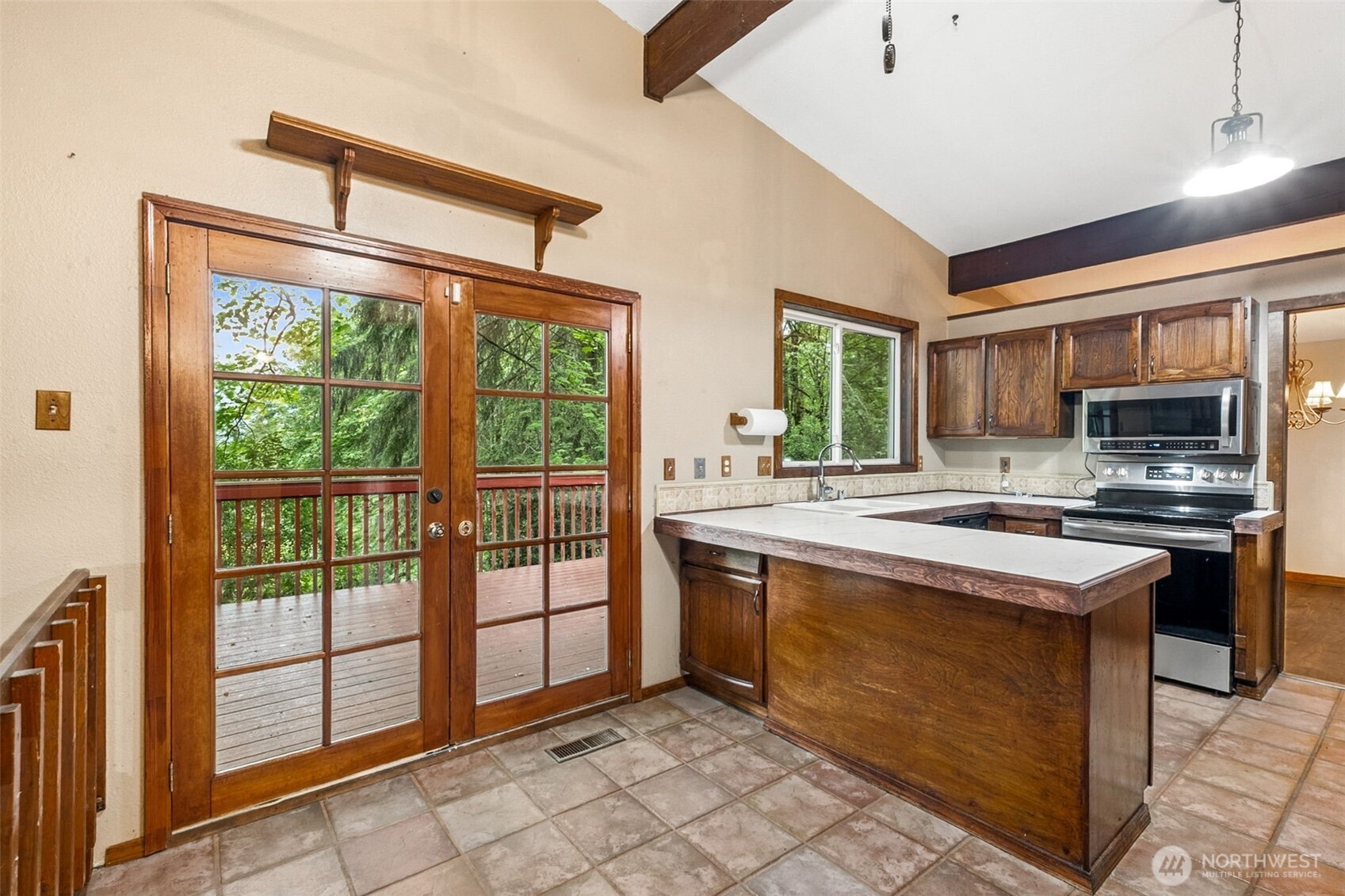 Beautiful wood french doors lead to back deck.