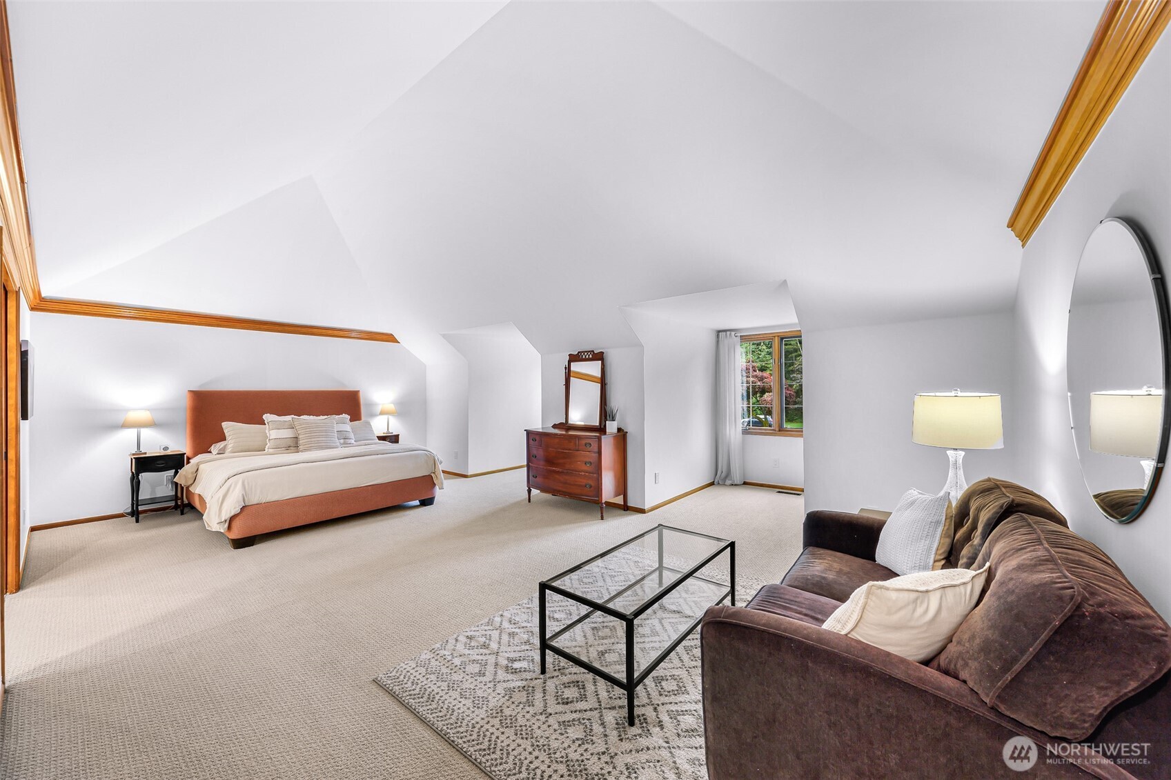 Extra large primary suite offers privacy and additional sitting area.