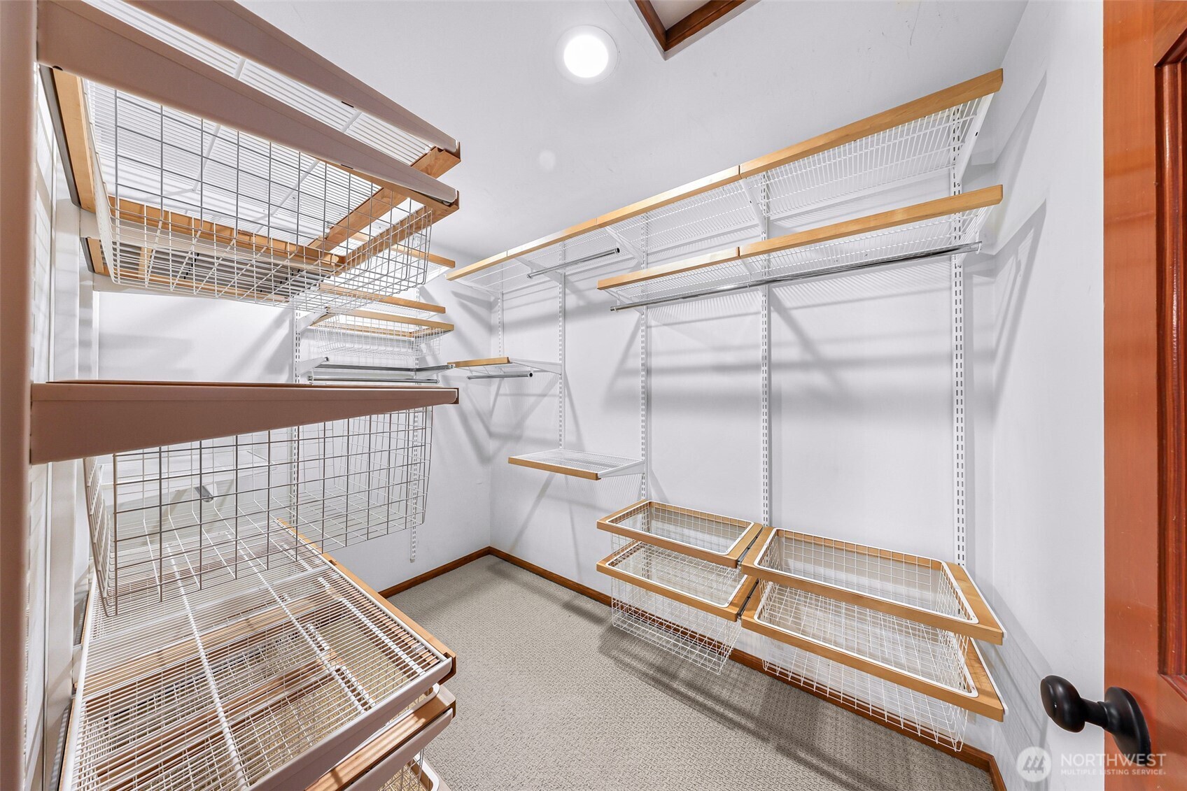 Primary walk in closet with organizers.