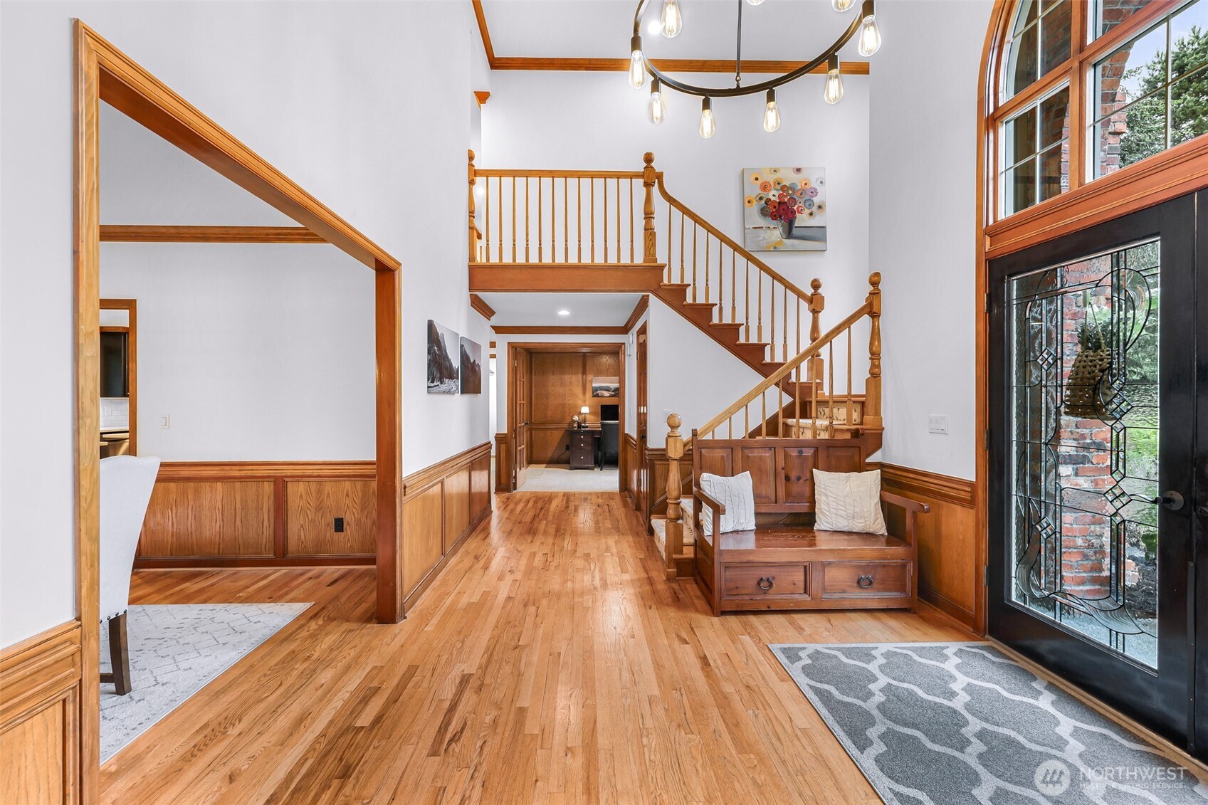 Entry way with gleaming hardwoods opening to living room, dining room and office.