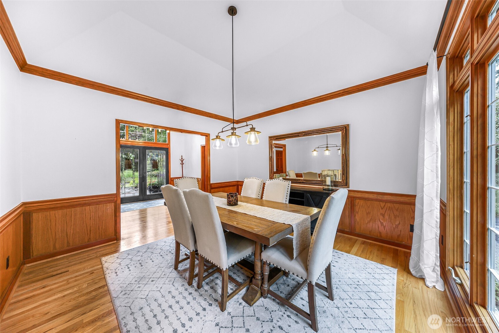 Large dining room with views of the lush yard.