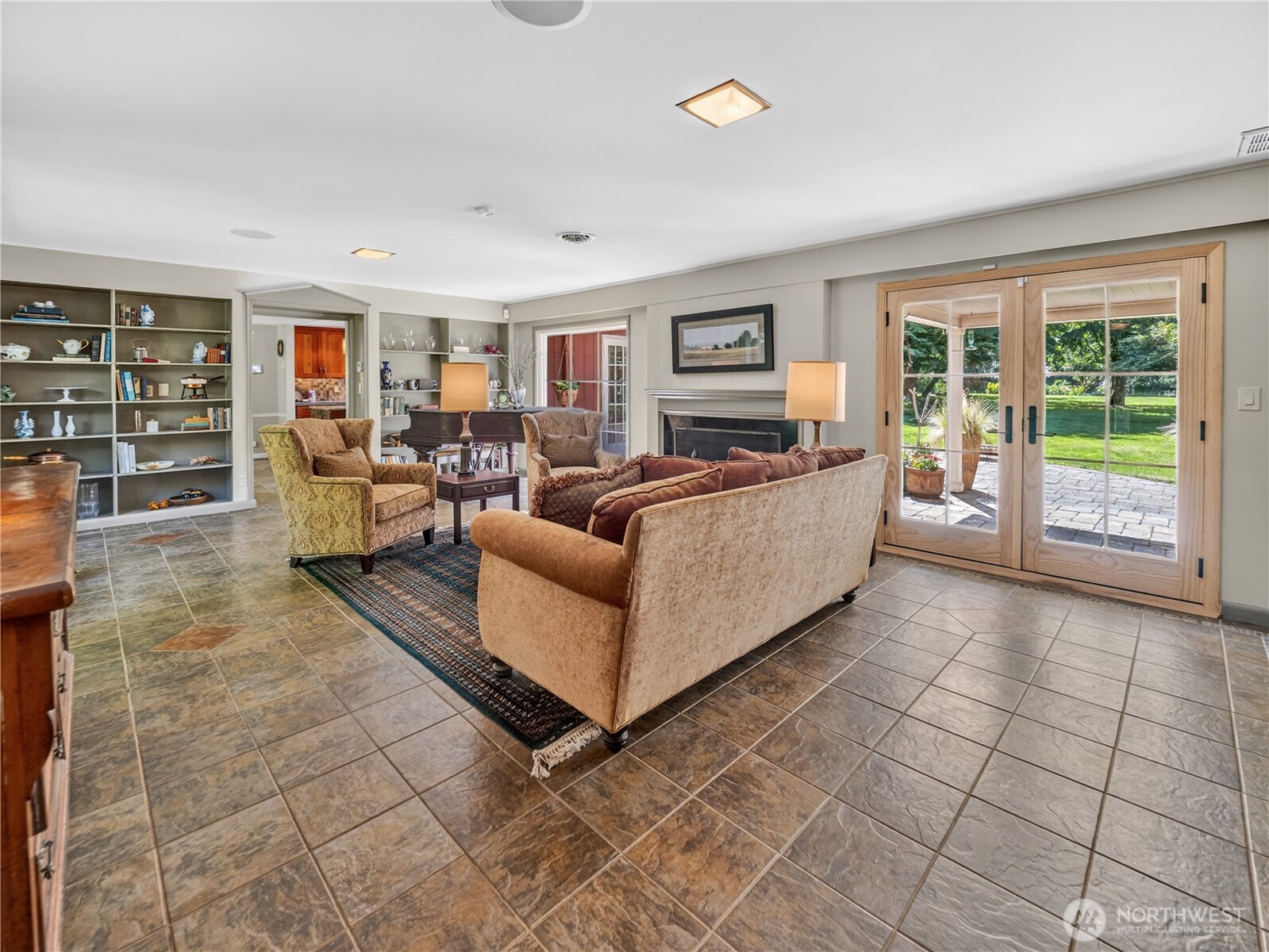 Formal living w/ tile floor & fireplace.