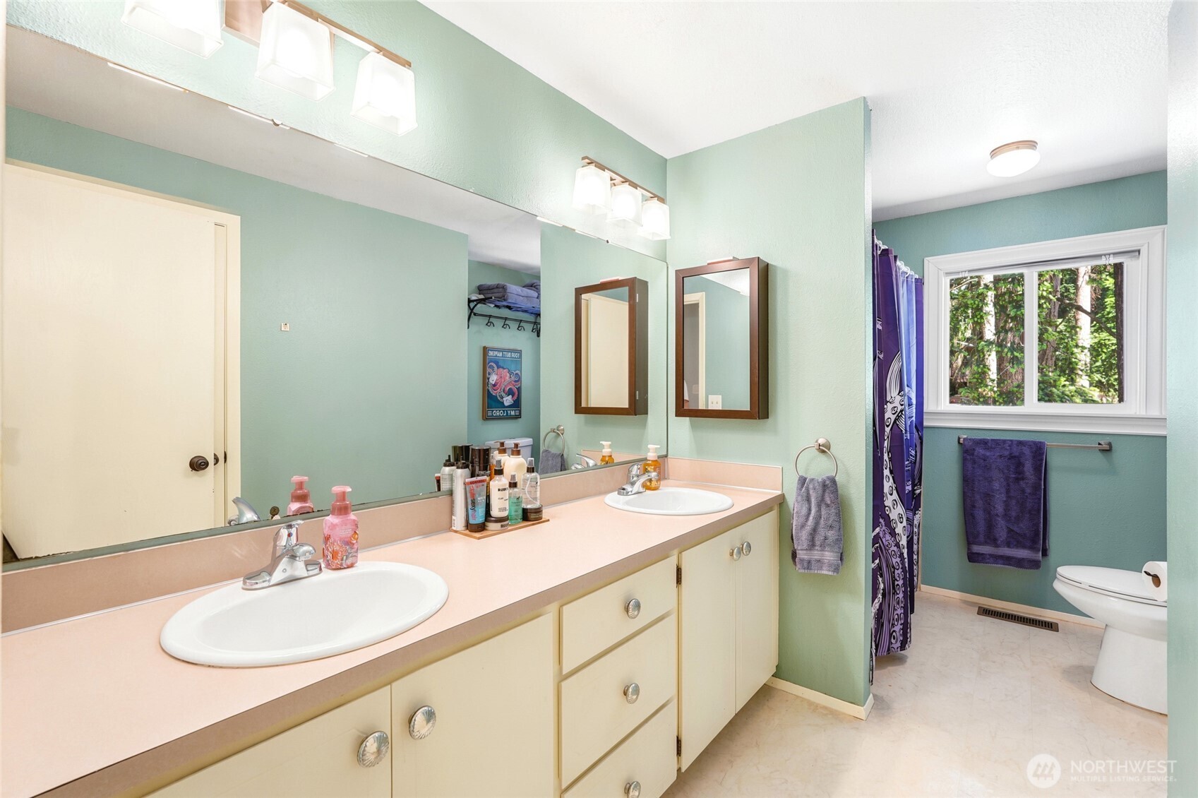 Main floor bath with double sinks, shower and bath.