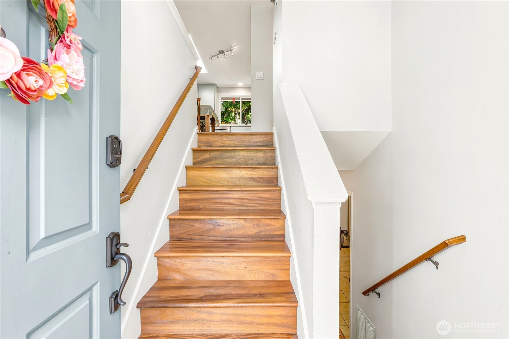 Split level entry with updated acacia hardwood floors.