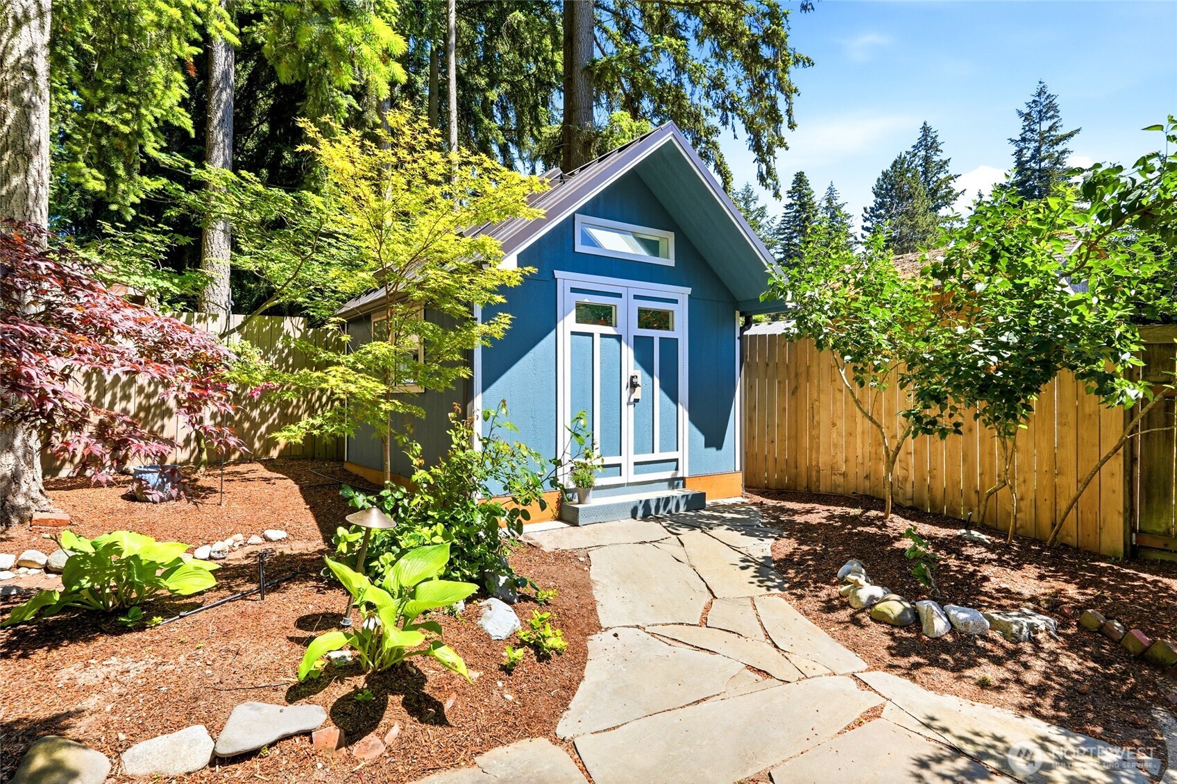 Fully finished backyard 'shed' with double doors.