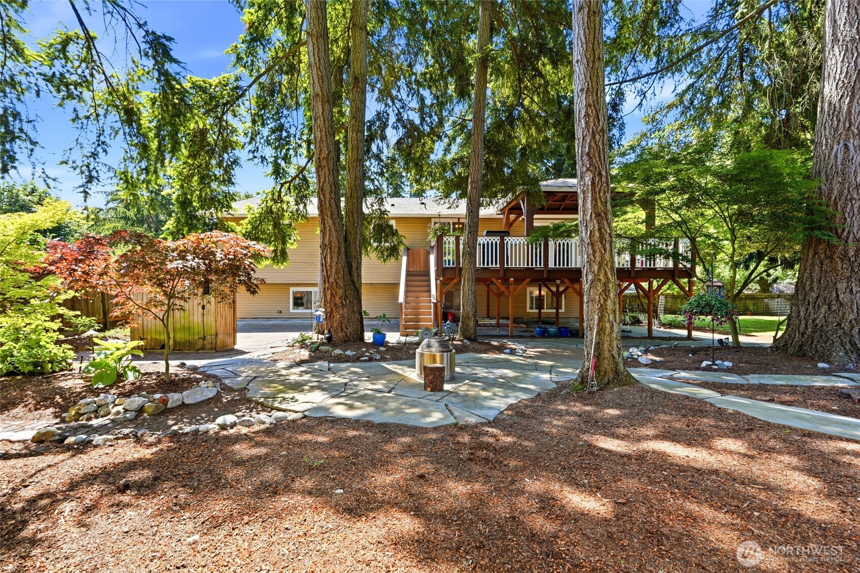 Oversized and fully fenced yard with tranquil paths and open spaces for gardening.