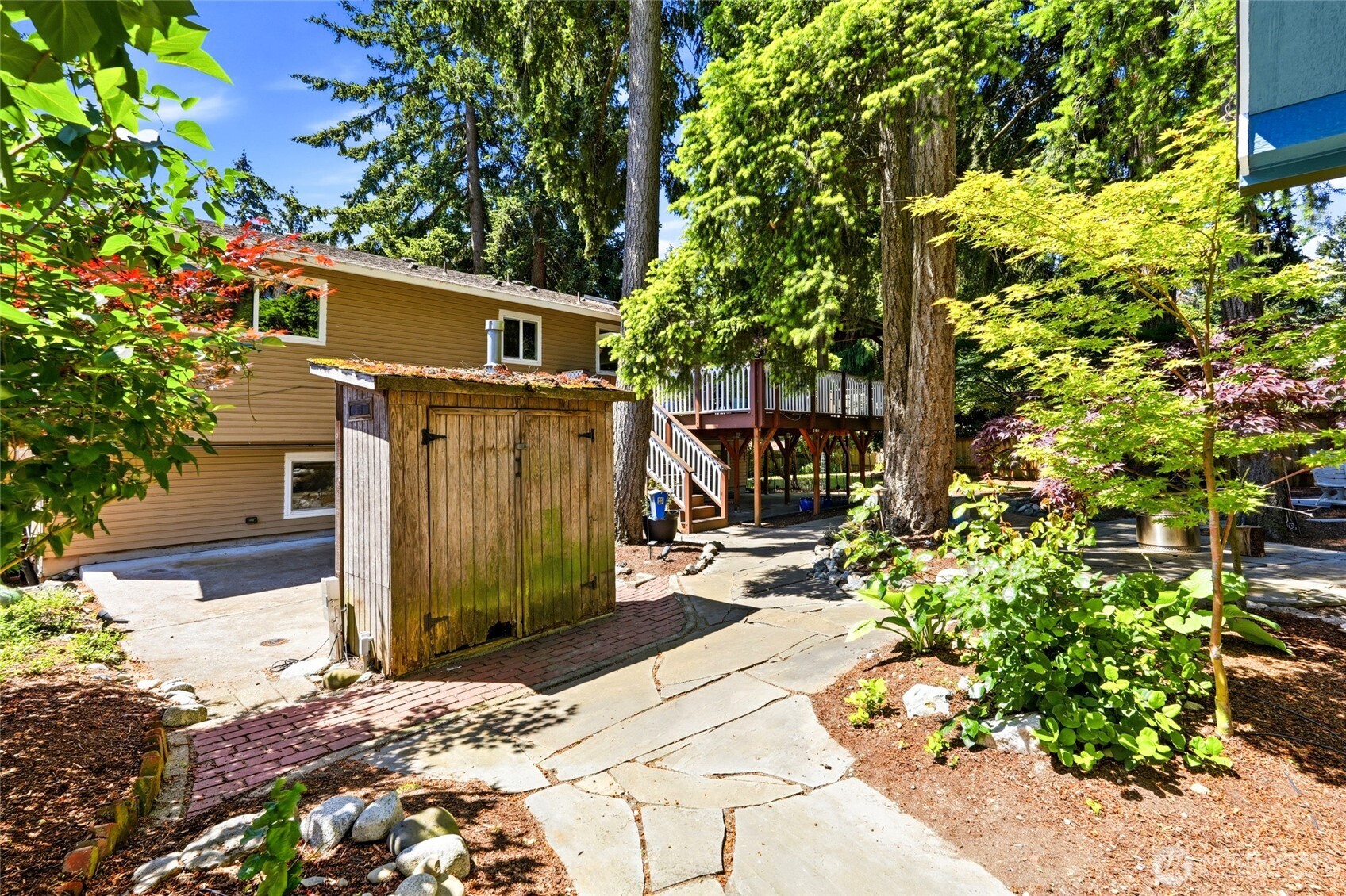 Outdoor shed for yard tools and hook up for outdoor spa.