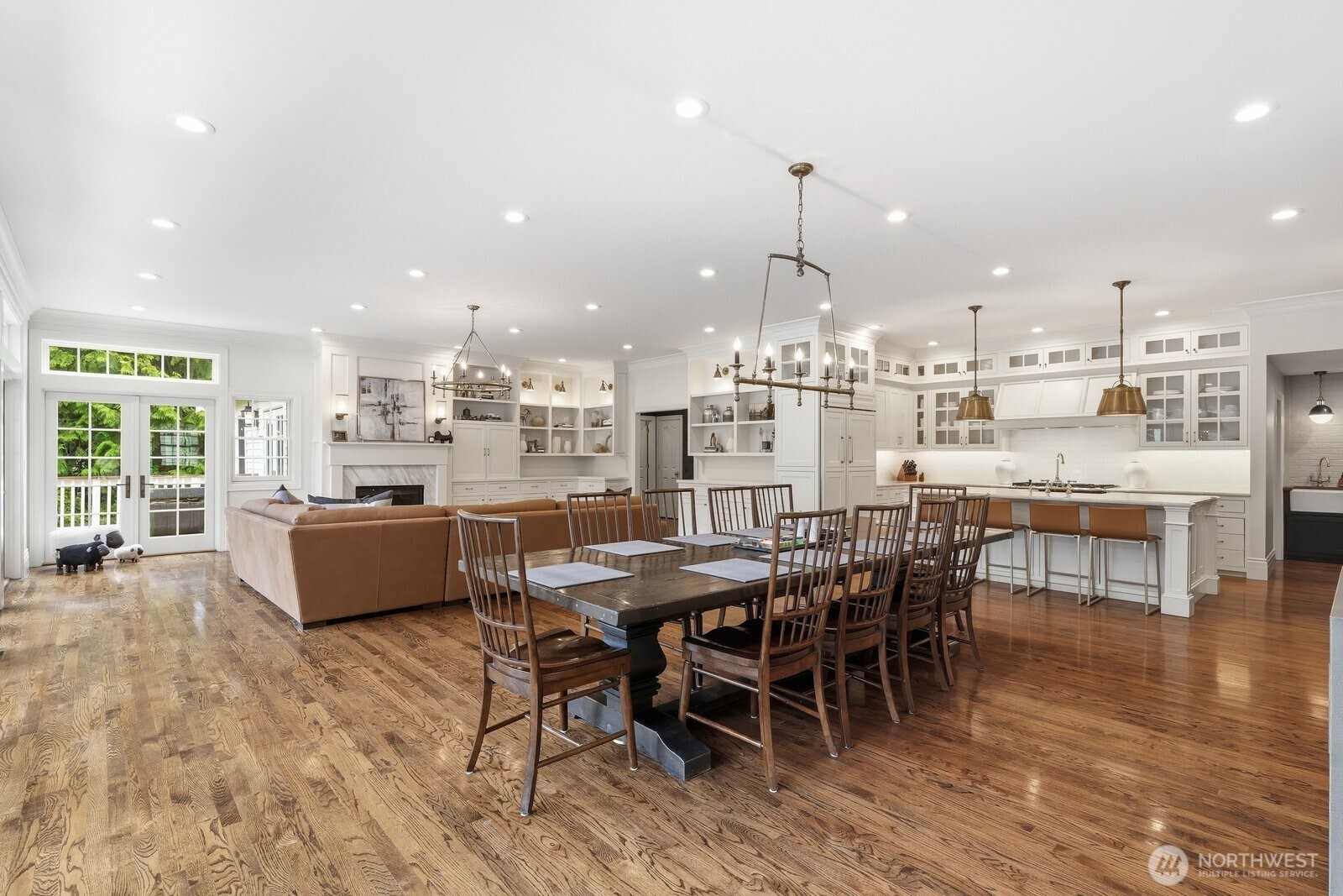 The crown jewel of the residence is the spectacular great room—a breathtaking gathering space defined by soaring ceilings and extensive bespoke custom cabinetry.