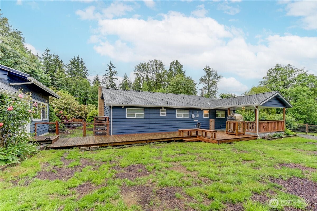 Ranch style home with covered deck adjacent to huge 1000 shop/garage with high bay door