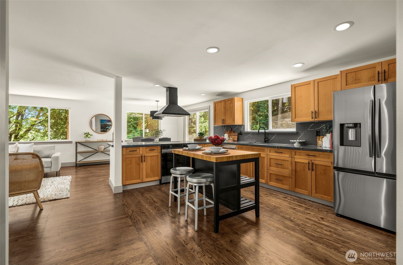 The remodeled kitchen serves as the heart of the home, seamlessly connecting gathering spaces designed for everyday living and entertaining.
