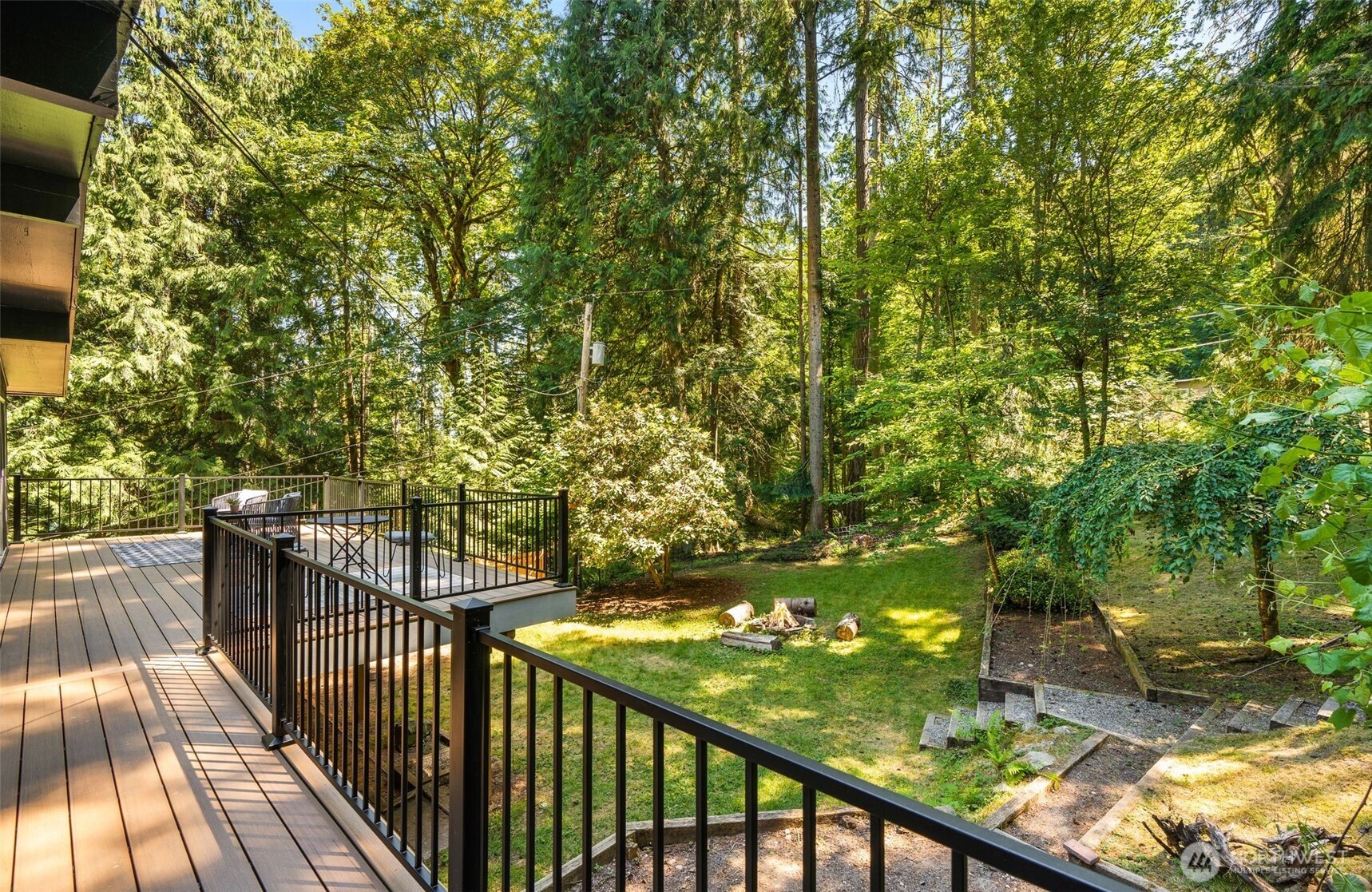 Step outside to enjoy nearly an acre of landscaped grounds featuring mature trees, fruit trees, garden space, a brand-new deck, and multiple outdoor living areas.