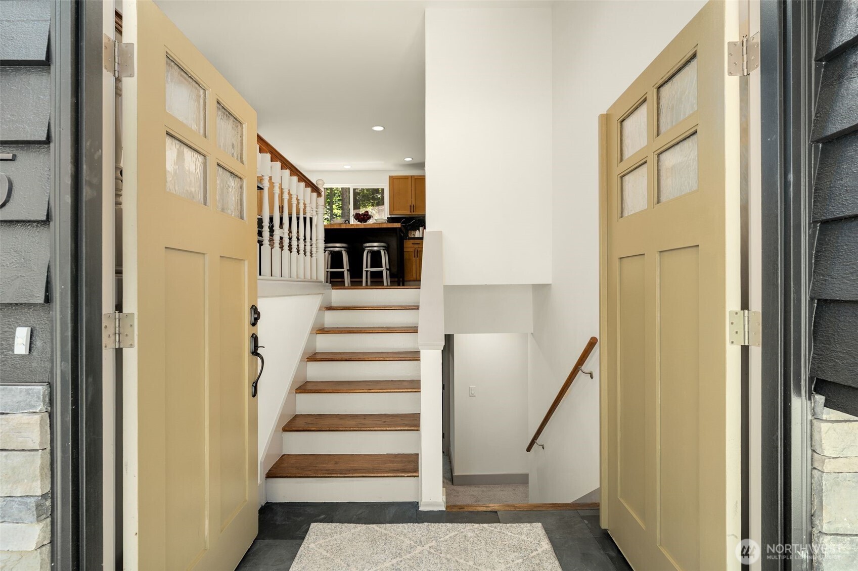 Double doors with transom window welcomes your guests.