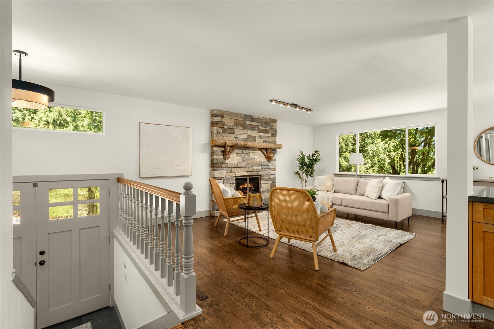 The living room boasts a stunning floor-to-ceiling fireplace, enhanced by a custom mantle that adds warmth to the space.