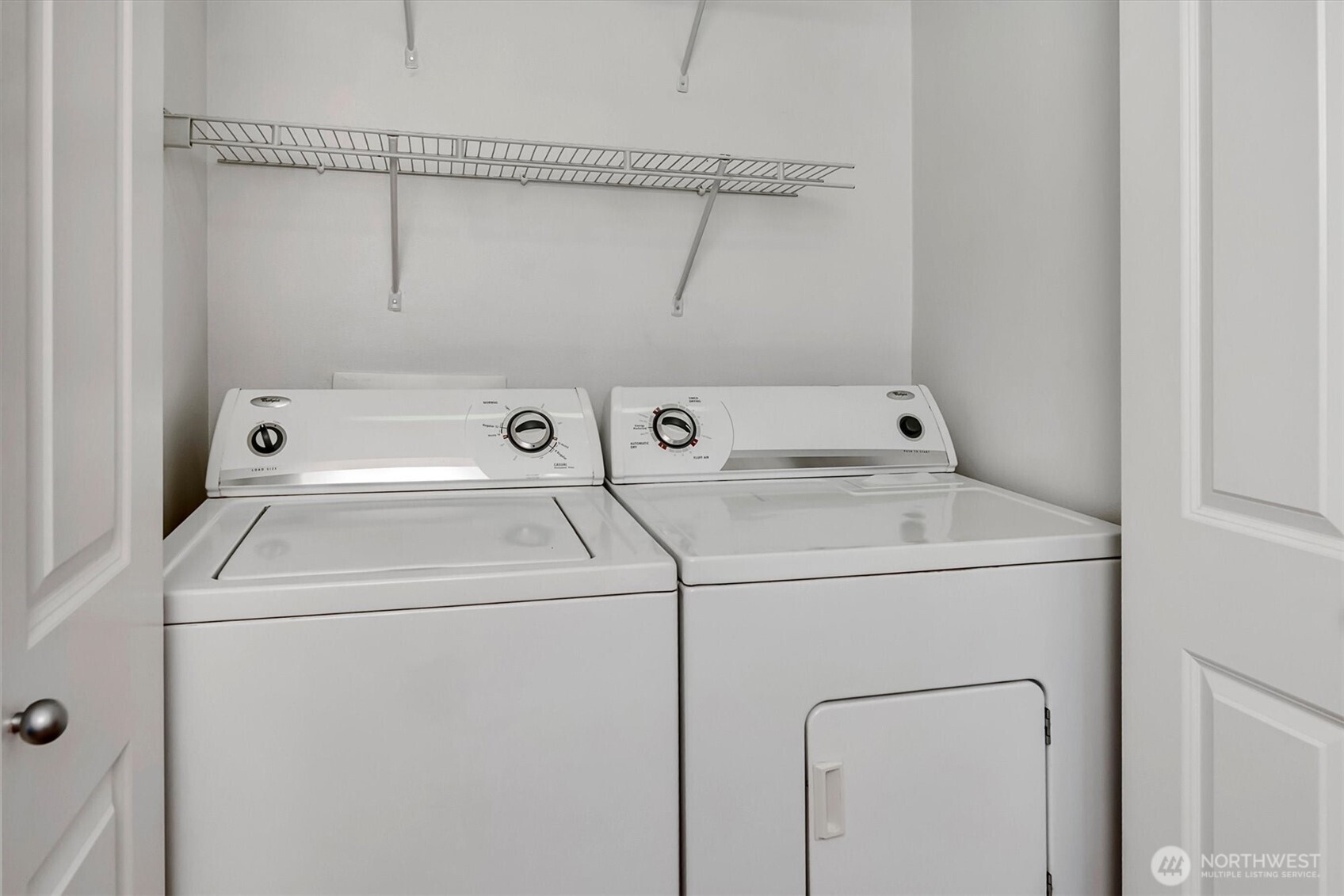 Laundry closet in hallway near den