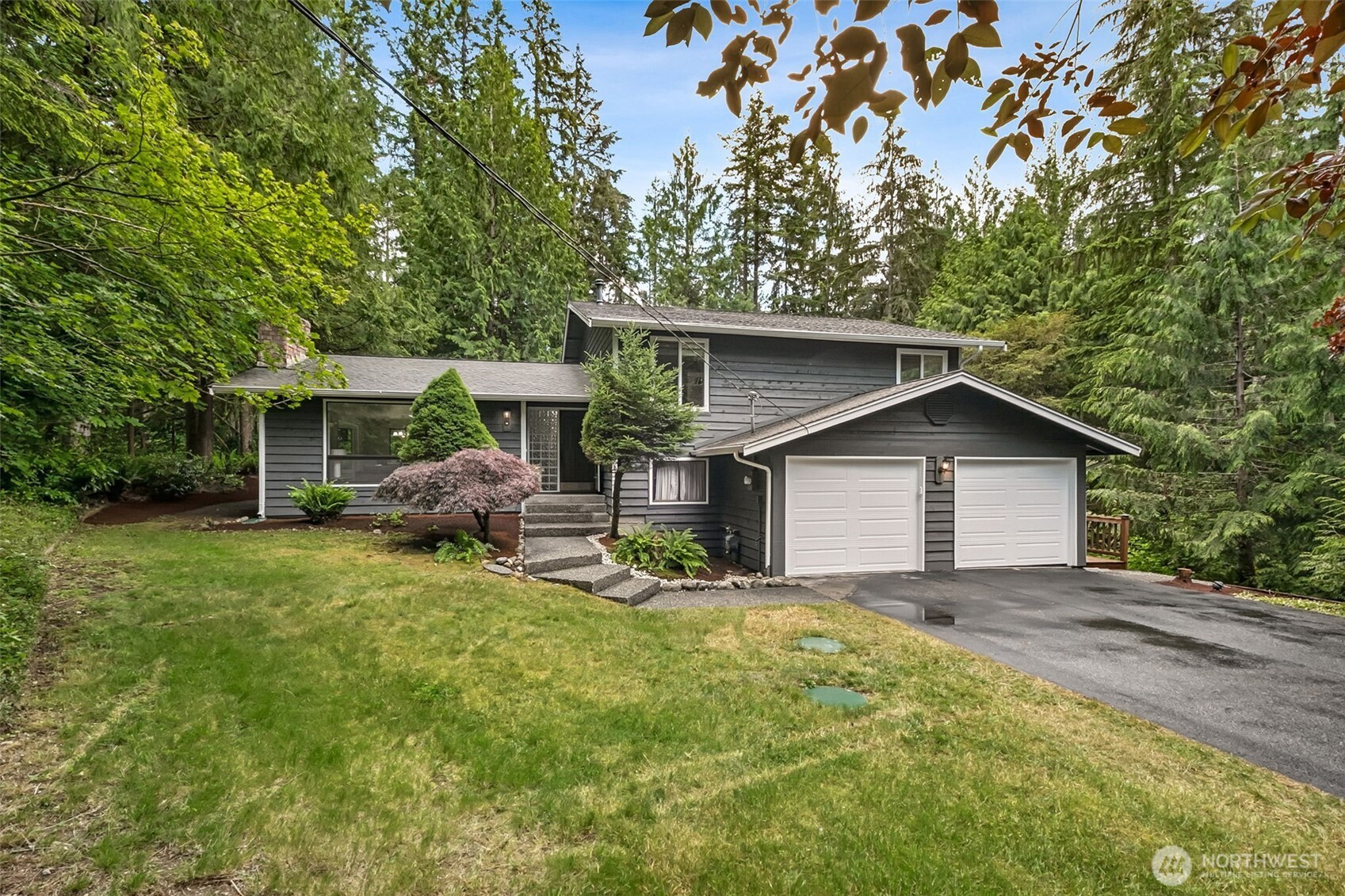 Welcome home to this beautifully refreshed tri-level nestled on a shy acre in the highly sought-after Mirrormont community on Tiger Mountain. Surrounded by towering evergreens and the natural beauty that makes Mirrormont so special, this move-in ready 4-bedroom, 2.5-bath home offers the perfect blend of updated comfort, usable space, and outdoor living.