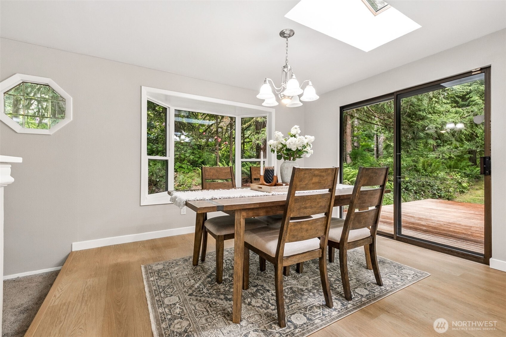 Here you can see the openness of the space, and both these half walls could be completely removed if a new owner wants to open up the space even more! Large slider door allows beautiful views of the back of the property. So green and gorgeous!