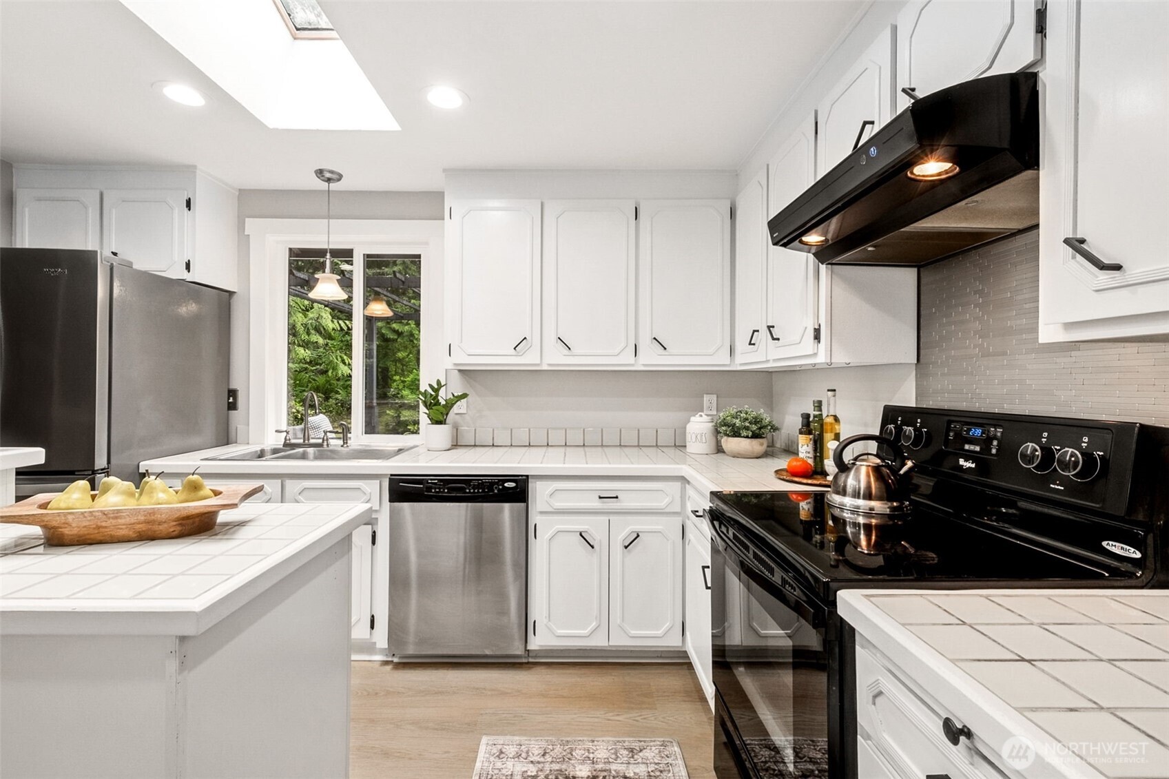 The classic tri-level floor plan offers an ideal balance of gathering spaces and private retreats. The kitchen opens seamlessly to the living and dining areas, creating a welcoming hub for everyday living and entertaining.
