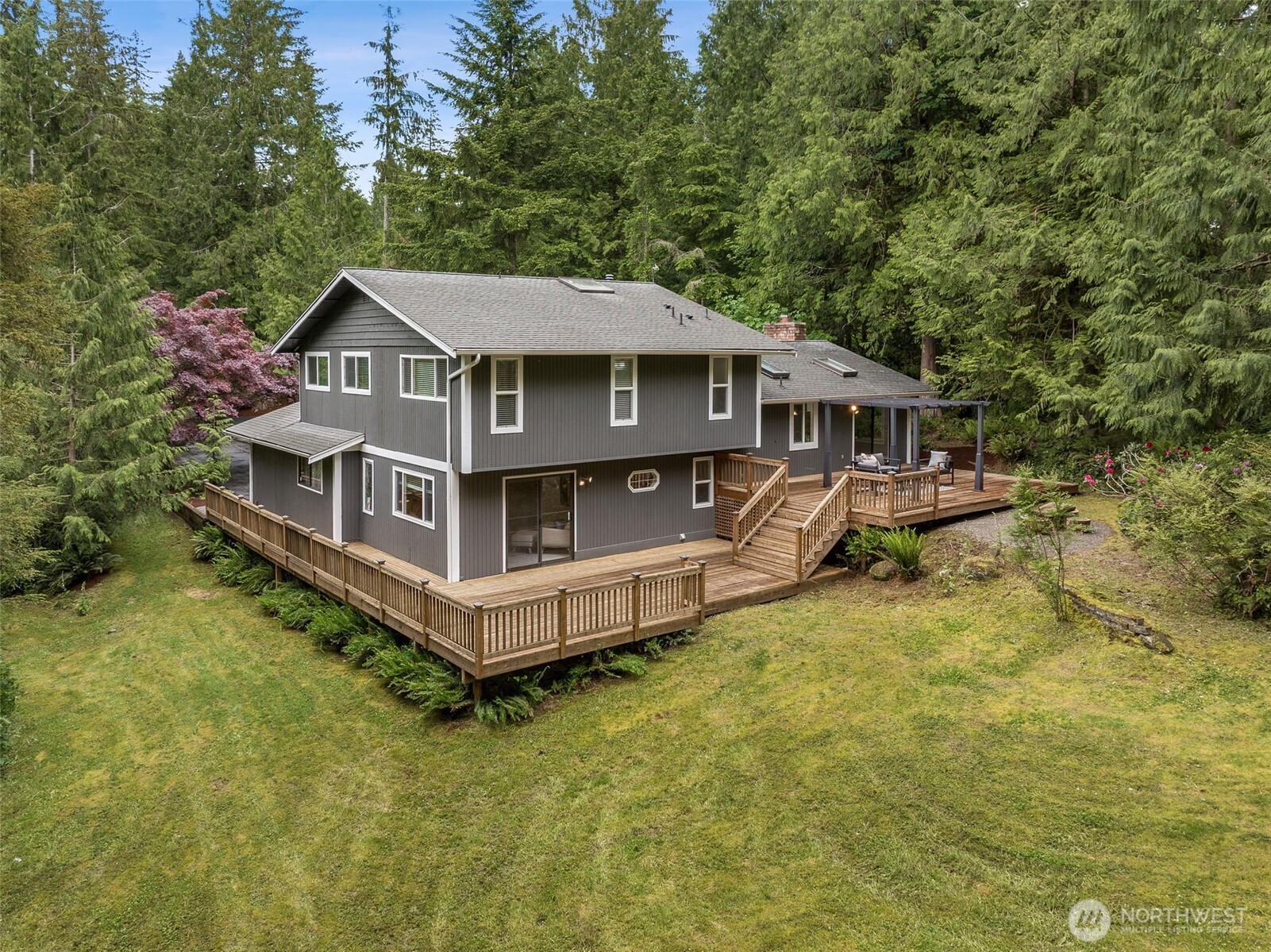 Outdoor living shines on this property. Enjoy summer gatherings on the expansive two-sided deck overlooking the flat, park-like yard. The nearly level lot provides endless opportunities for gardening, recreation, or simply enjoying the peaceful surroundings. Freshly painted exterior of the home plus trim means years of easy living!