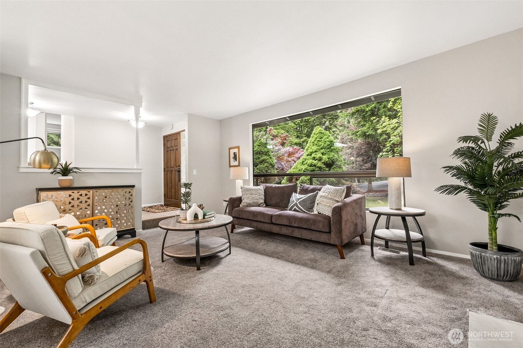 A beautifully updated wood-burning fireplace with new tile surround serves as the centerpiece of the main level living room, w/new carpet and new paint throughout.