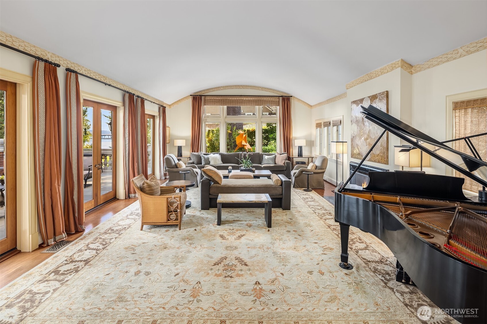 The expansive living room with fireplace provides a perfect gathering space.