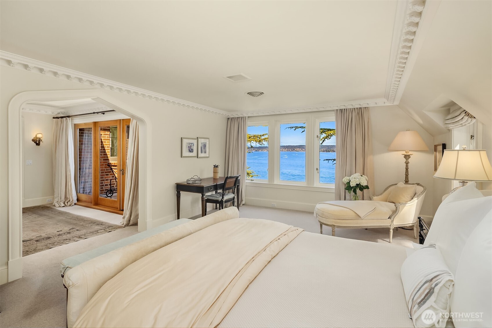 Upstairs enjoy the primary suite with private balcony and sweeping views.