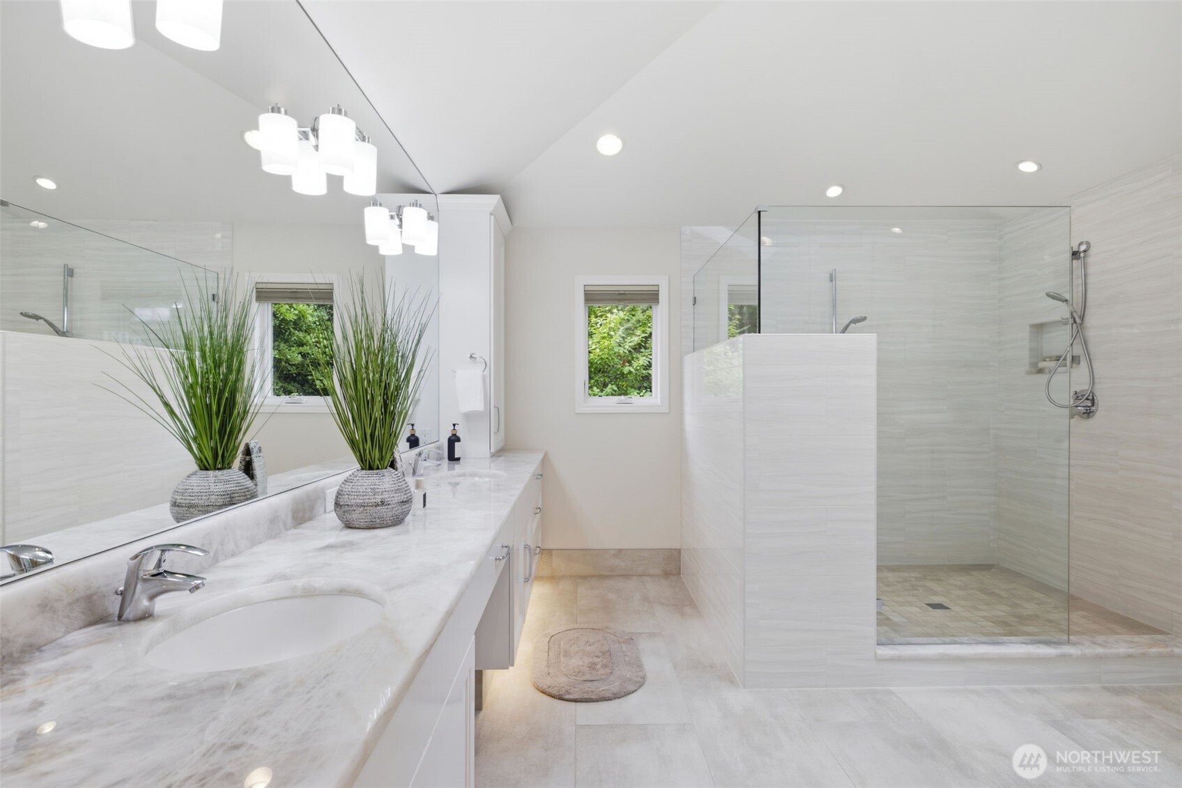 Separate sinks and a wall of built in cabinetry