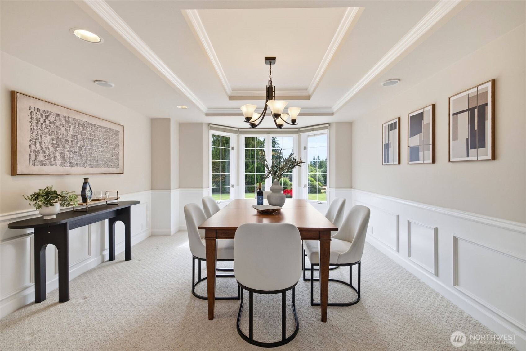 Formal dining room with bay windows overlooking the yard