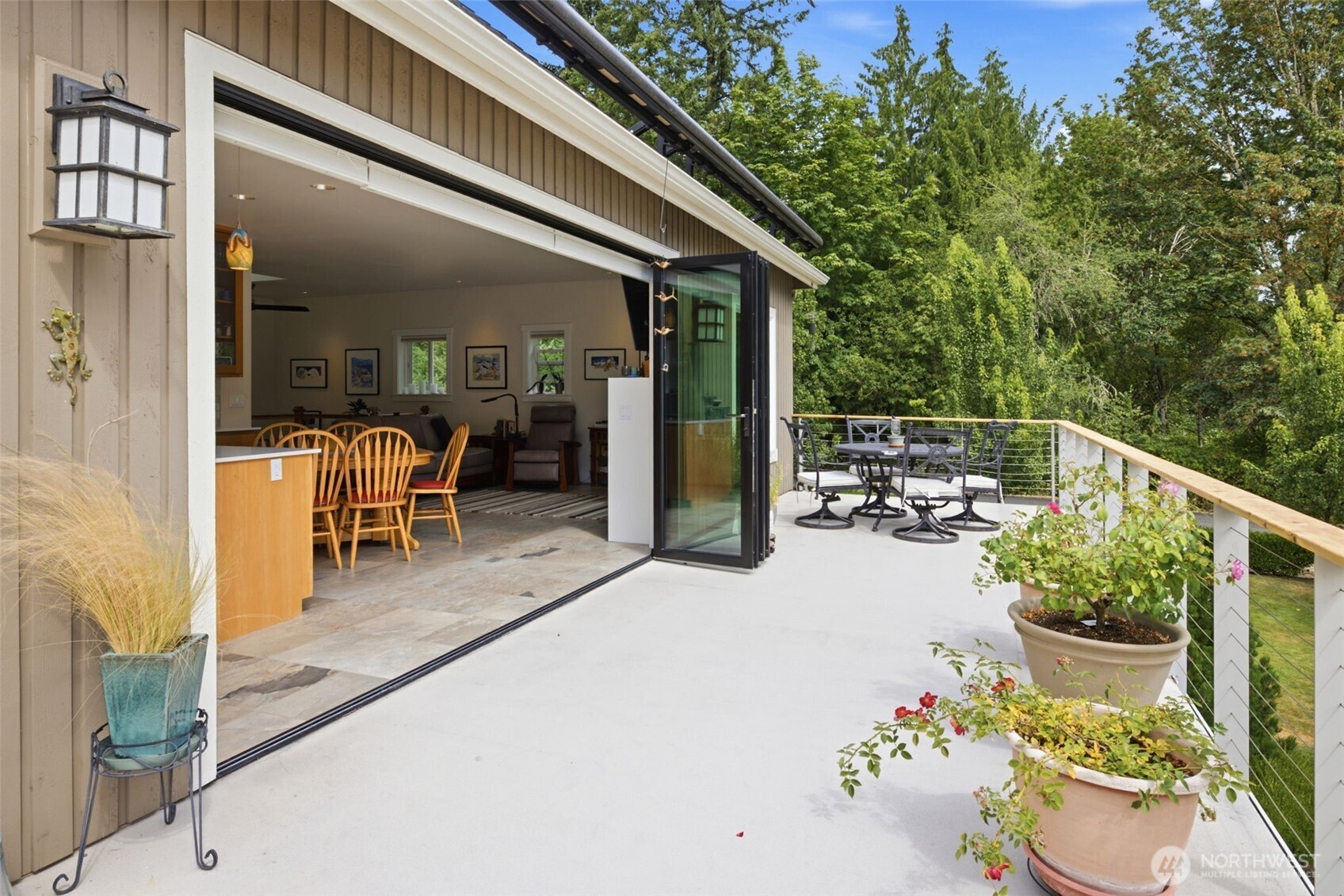 Retractable wall of windows open the DADU to the wrap around porch. Enjoy coffee with a view!