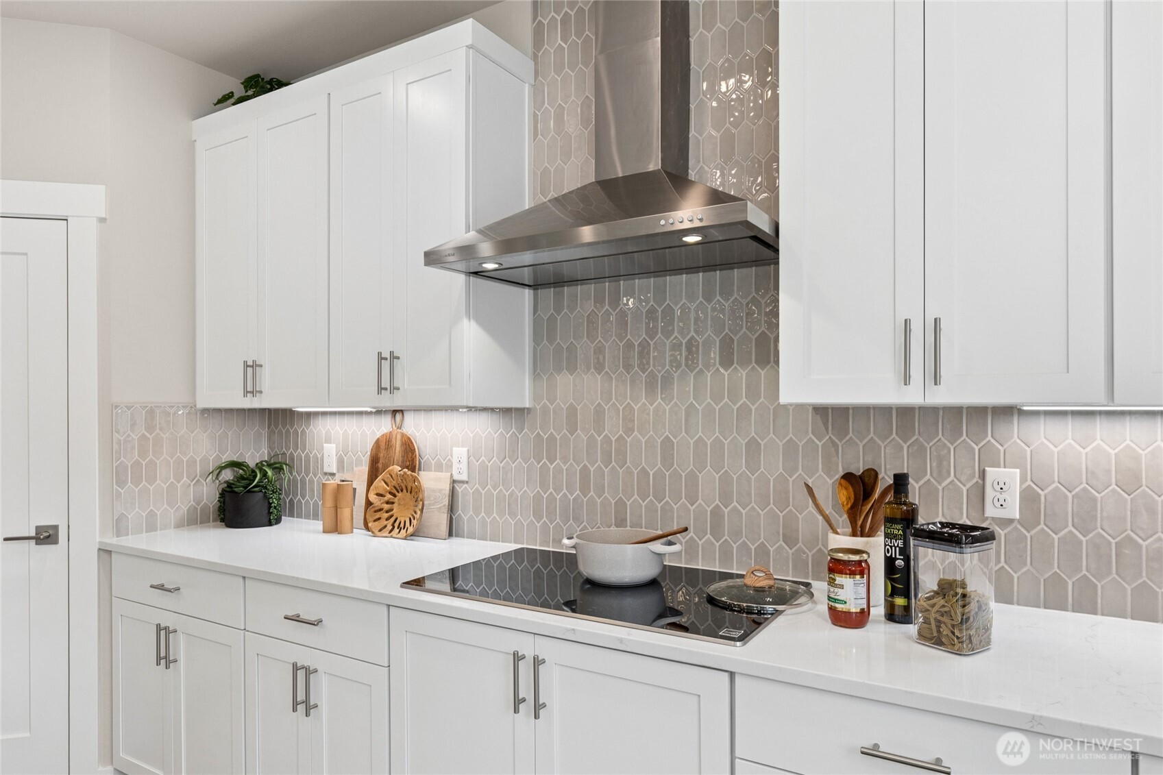 State of the art induction cooktops and full height tile backsplashes make kitchen cleaning a breeze!