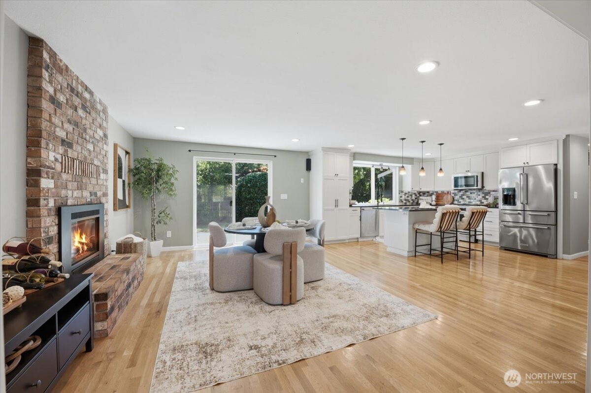 Open concept kitchen and dining with gas fireplace