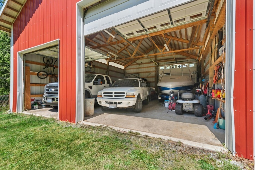 Large TimberTech deck with hot tub overlooks acre+ lot with sweeping views.