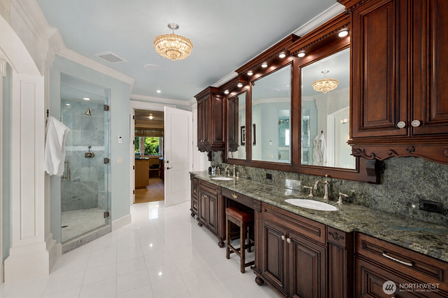 The spa-inspired primary bath features dual vanities, premium finishes, a walk-in shower, and a layout designed for relaxation.