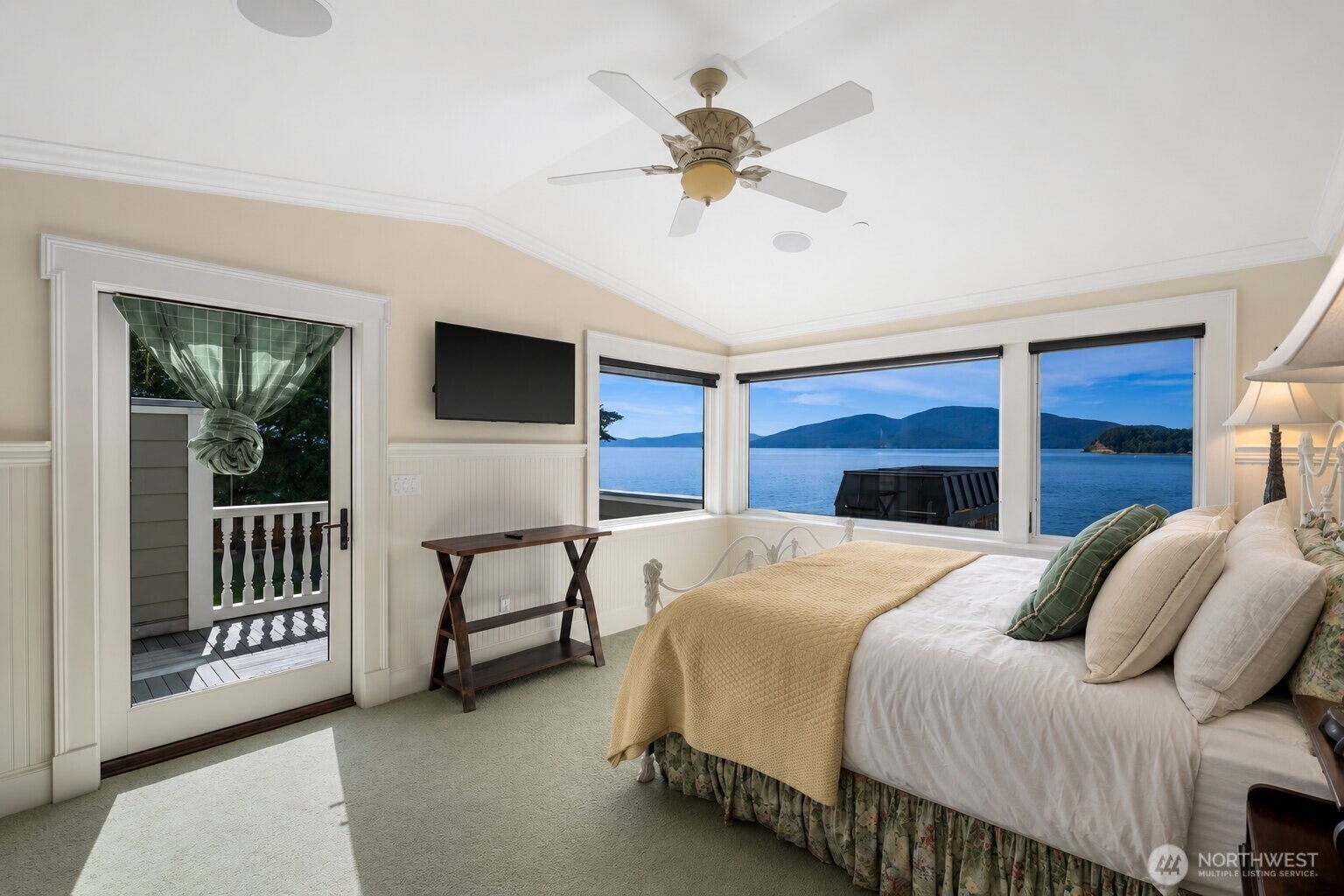 A spacious guest suite with private deck offers comfort and privacy with beautiful natural light and picturesque views.