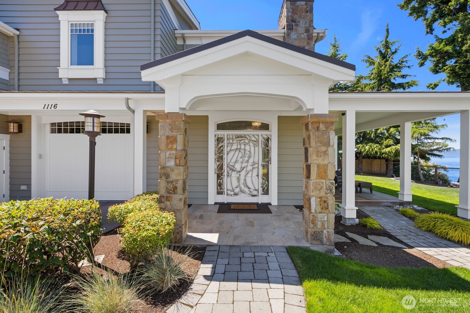 A timeless front entrance welcomes you to the guest cottage with classic architecture, manicured landscaping, and exceptional curb appeal.