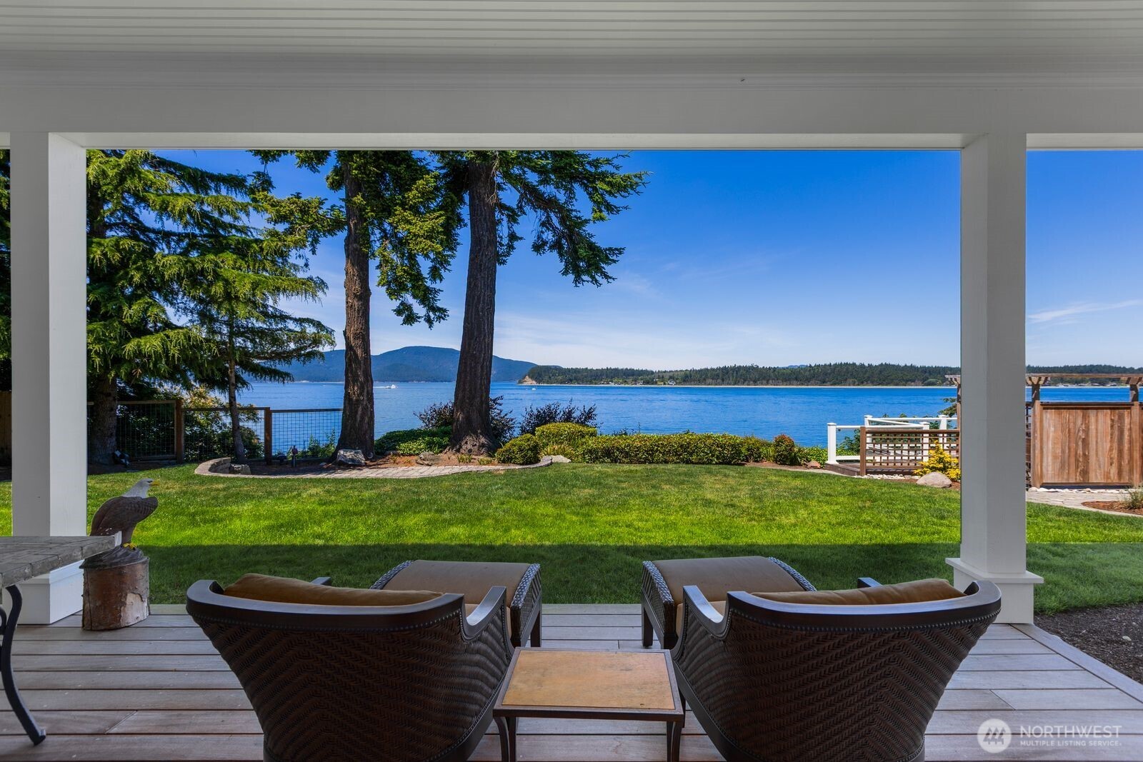 The guest cottage's covered patio creates the perfect setting for morning coffee, evening conversations, and taking in the ever-changing views
