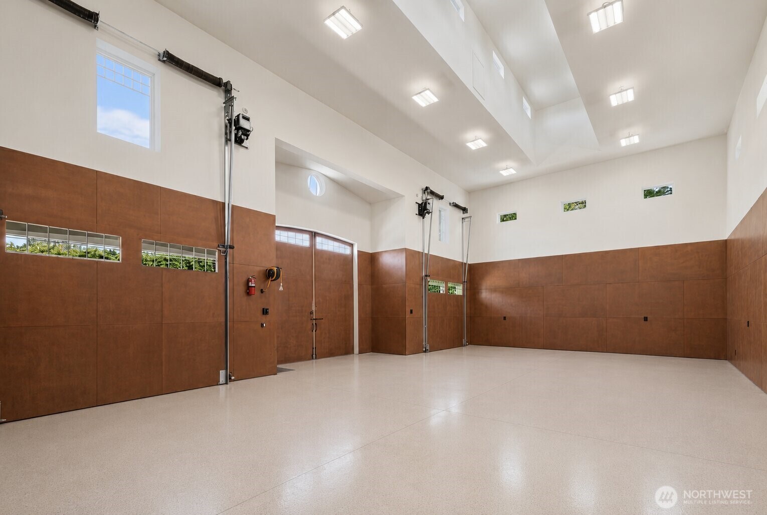The oversized heated garage offers exceptional flexibility with ample space for multiple vehicles, hobbies, storage, and recreational equipment.