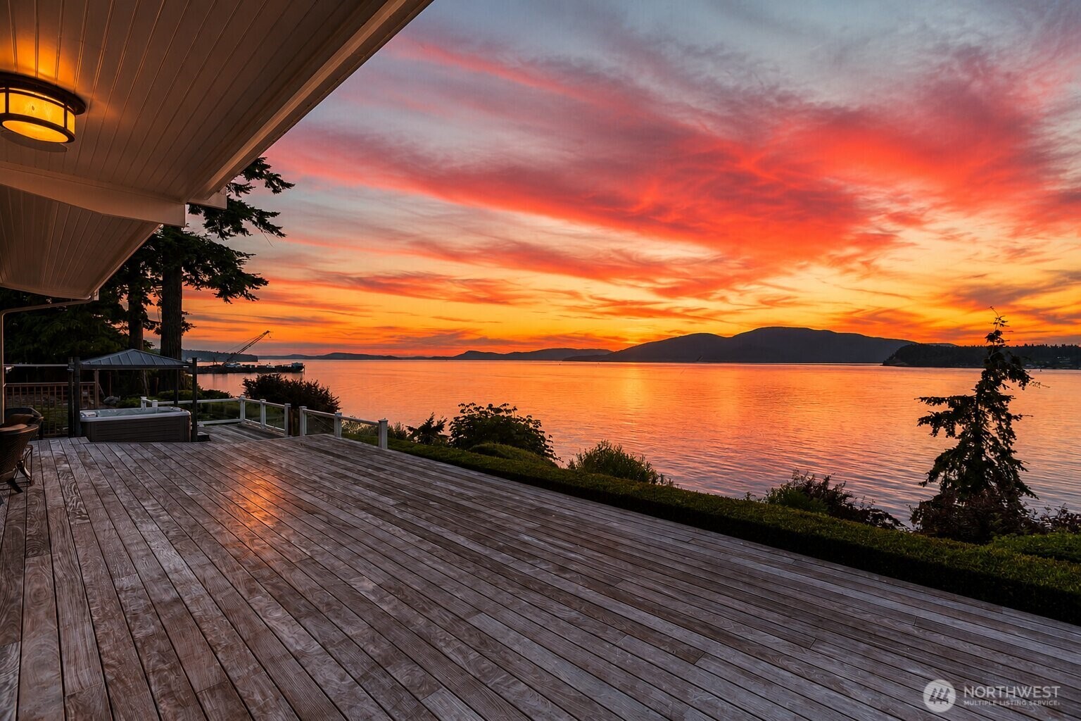 Experience unforgettable Northwest sunsets from your private deck, where vibrant skies and tranquil waters create the perfect backdrop.